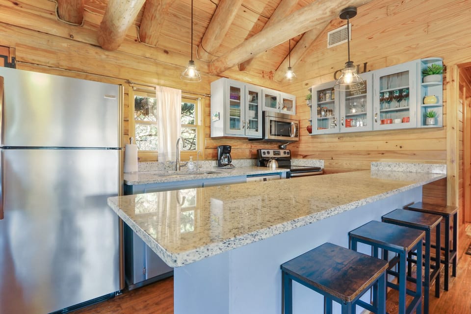 Full kitchen with stove, oven, refrigerator, microwave, and coffee maker
