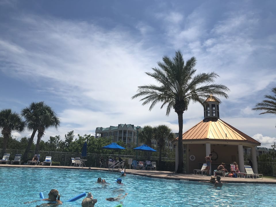 Pool with bar and barbecue place on the background.