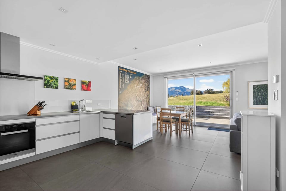 As viewed from the entrance, kitchen/dining flowing out to the patio and lawn