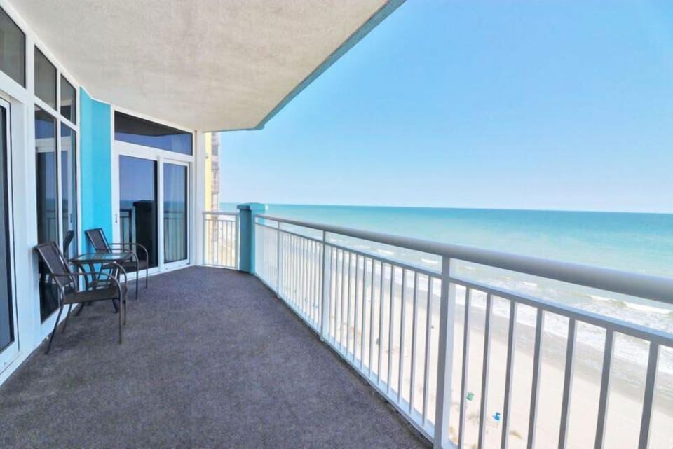 Extra-wide balcony with seating. Perfect for coffee, sunsets, and salt air.