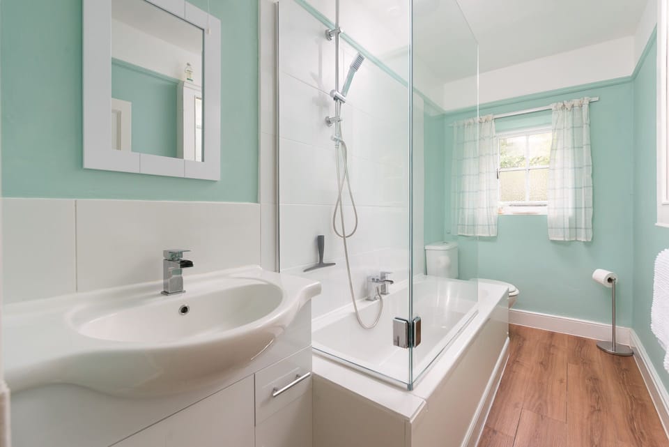 Recently renovated bathroom with rainfall shower over the bath