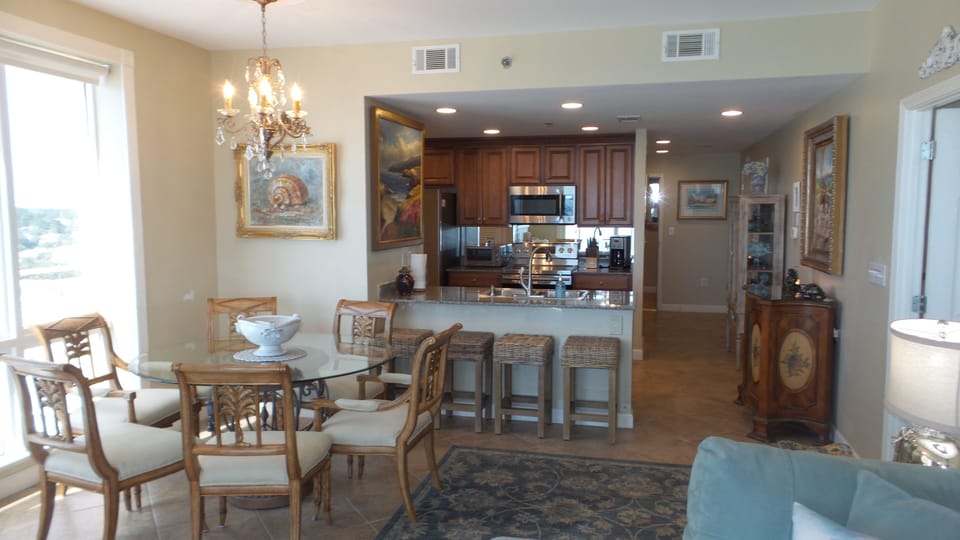 View of kitchen, dining room and hallway from the living room (high-end decor). 