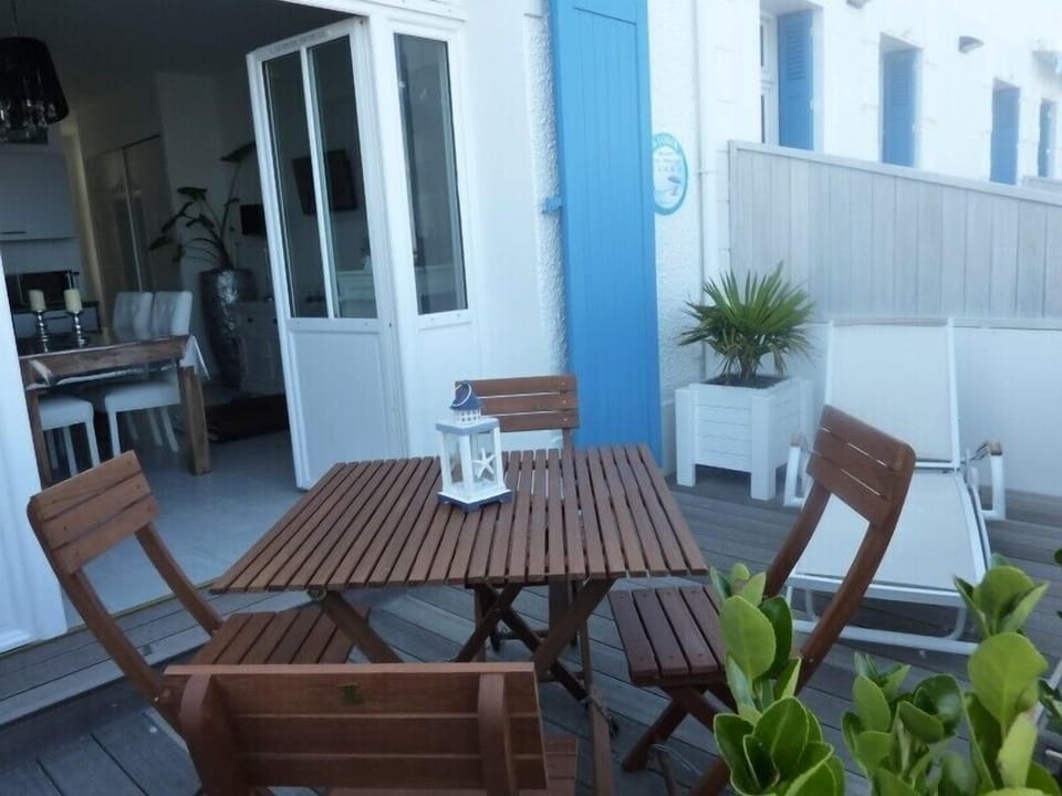 Wooden terrace with table and deck chair
