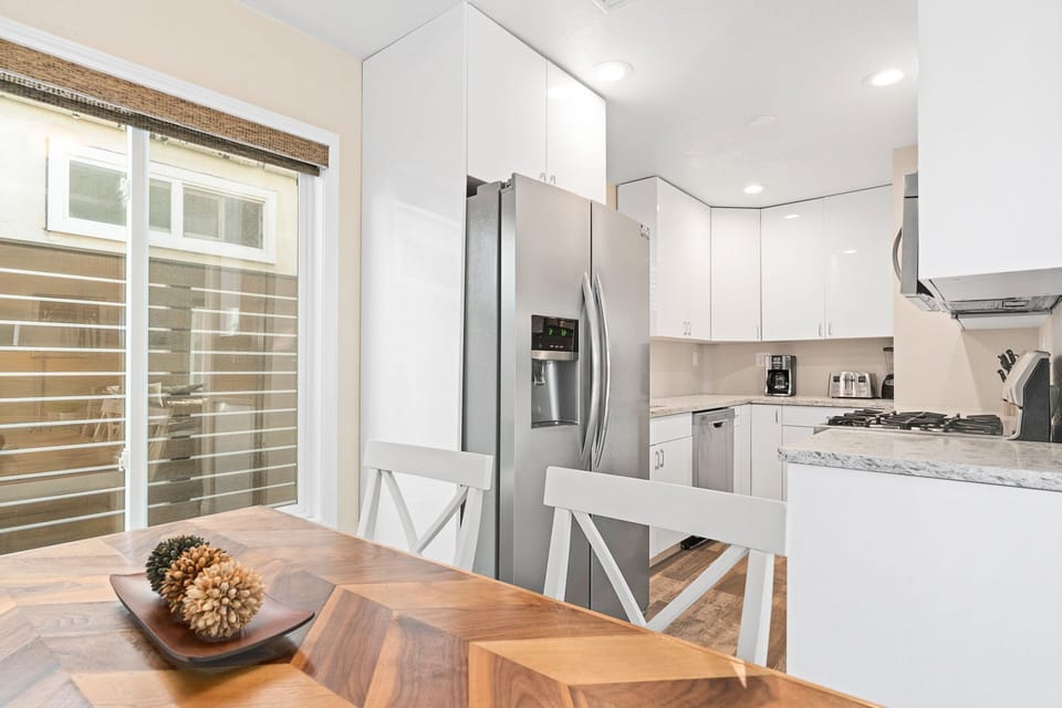 The dining table seats four and opens up to the fully-stocked kitchen.
                