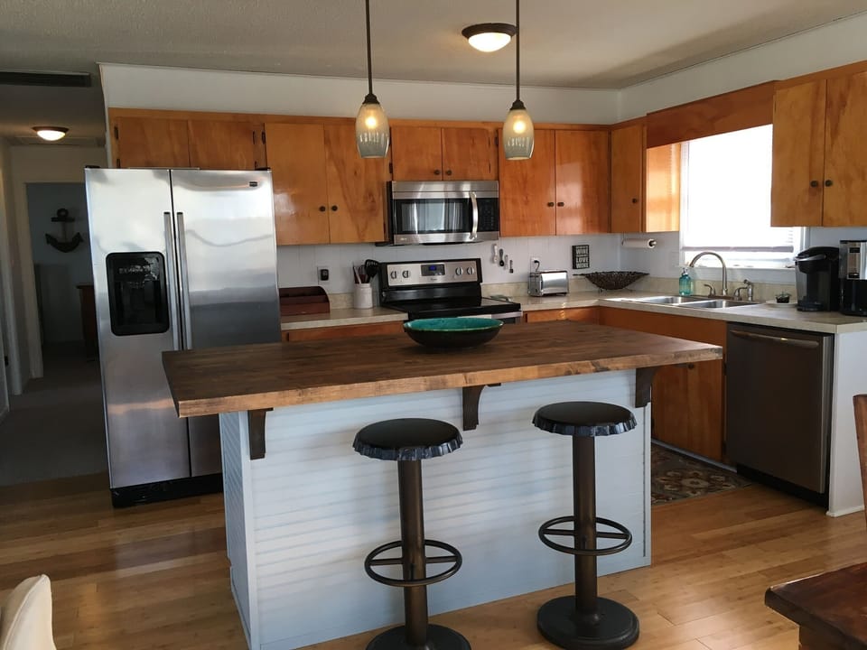 Full, well appointed  kitchen with island seating.