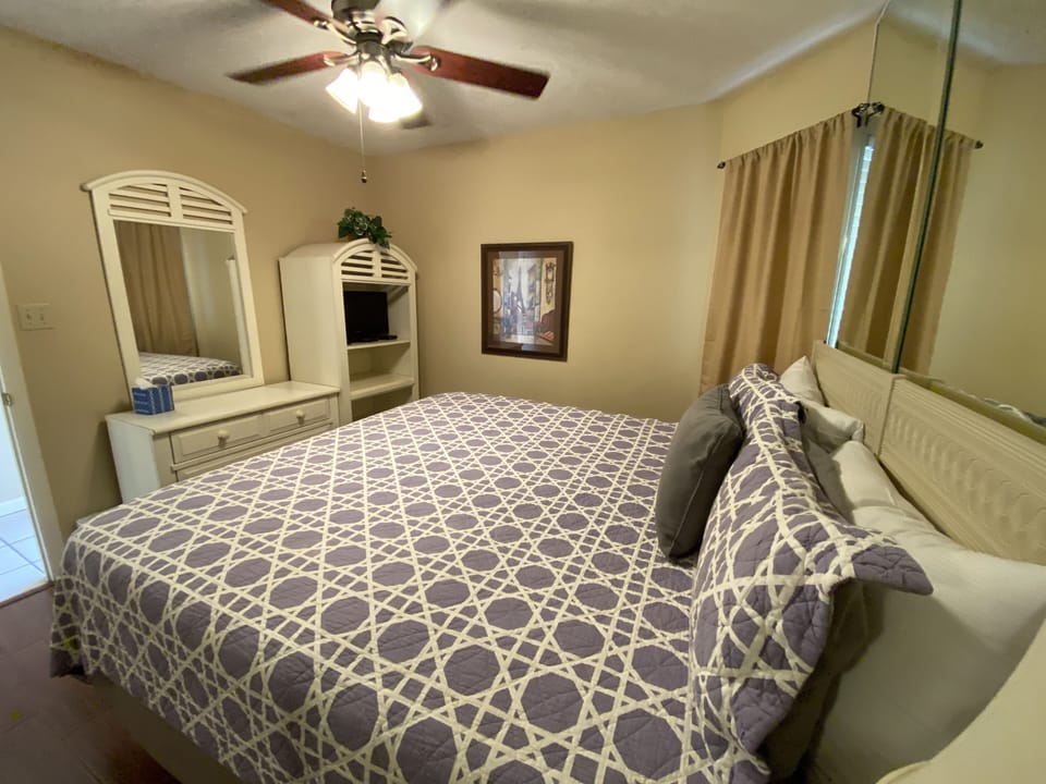 Cozy up in our chic master bedroom with a king size bed and full length mirrors!