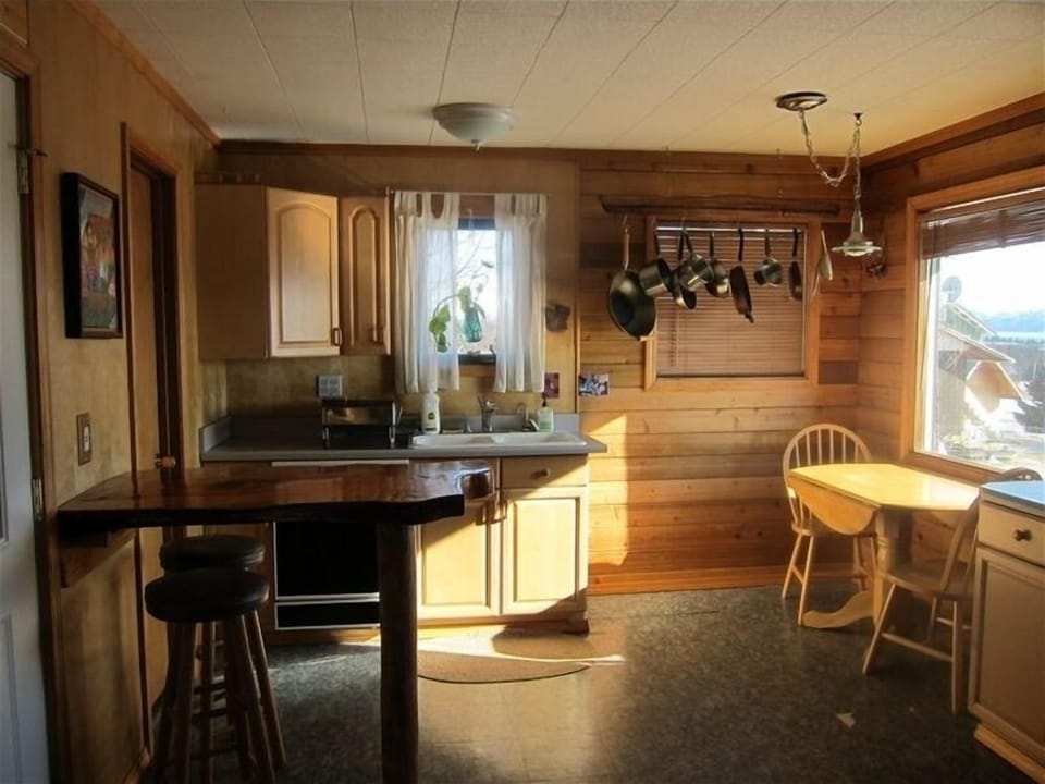 Small table and custom crafted breakfast bar in kitchen
