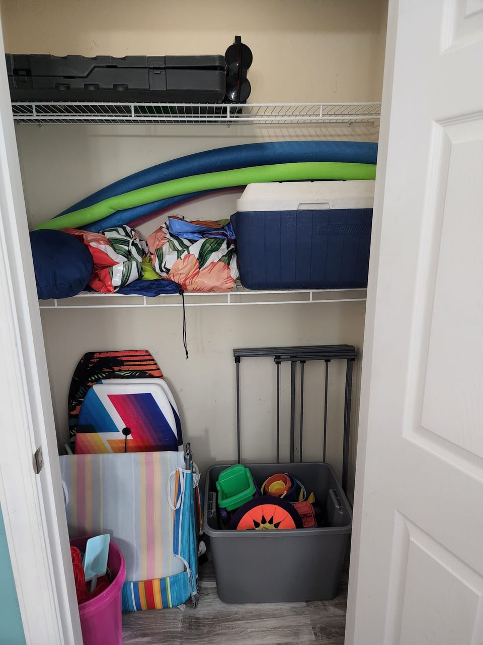 Closet full: water boards, sand toys, chairs, umbrella, and cooler for your use