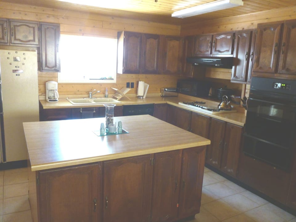 Fully outfitted kitchen with island, gas stove & oven, microwave, crock pot, etc