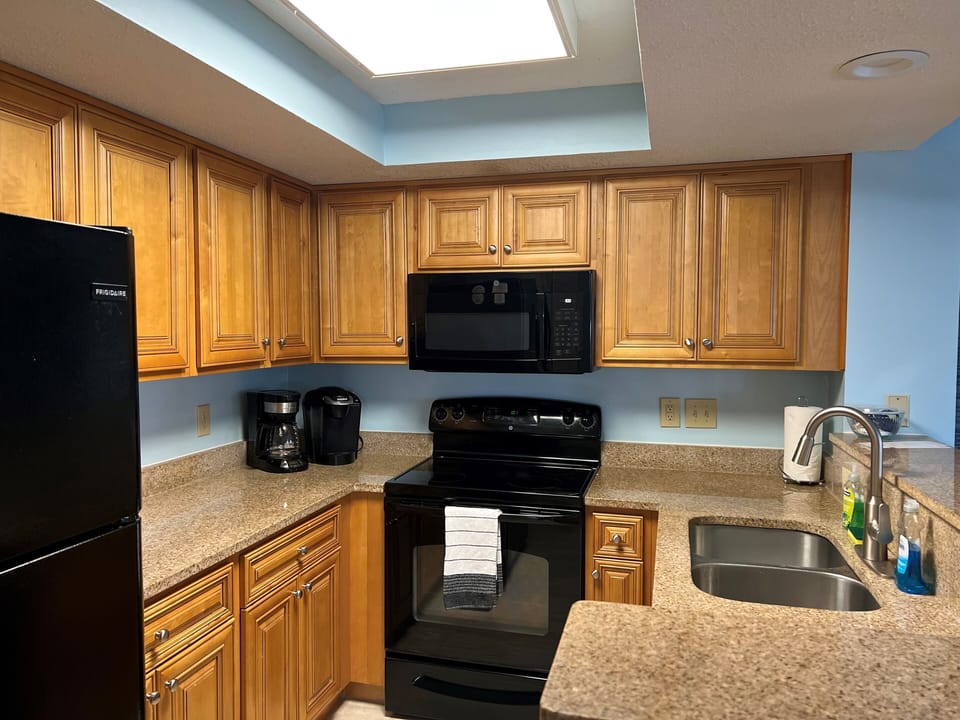 Kitchen with granite counter tops and full size appliances