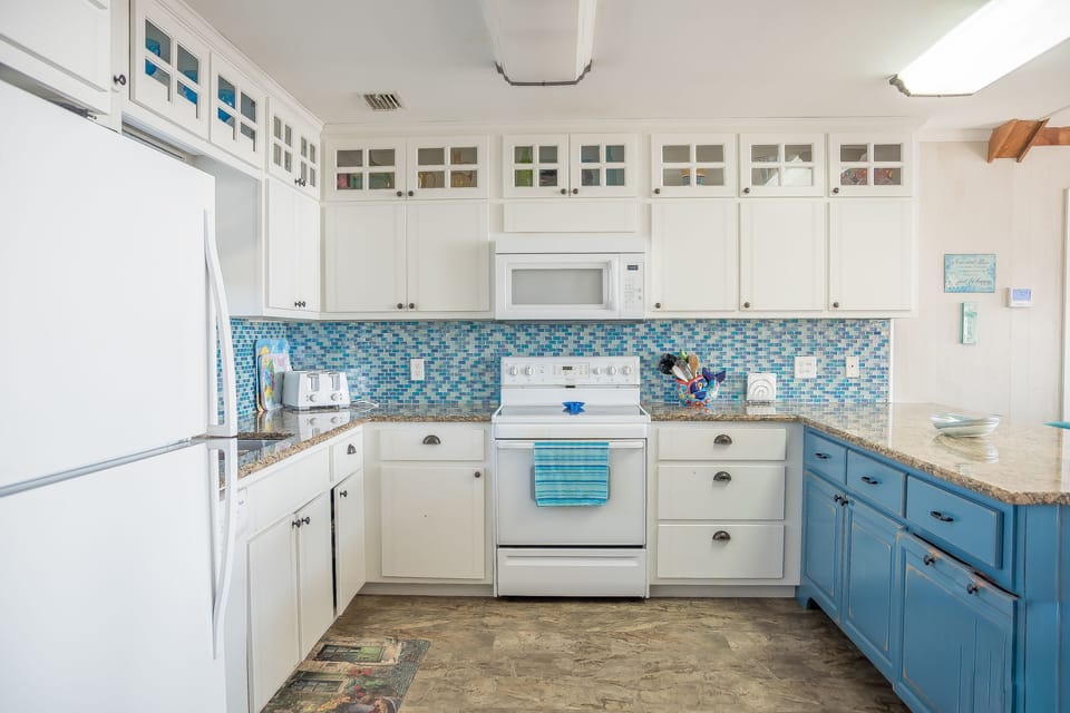 Kitchen w smooth top range, DW, fridge w ice maker, Bunn coffee pot, microwave