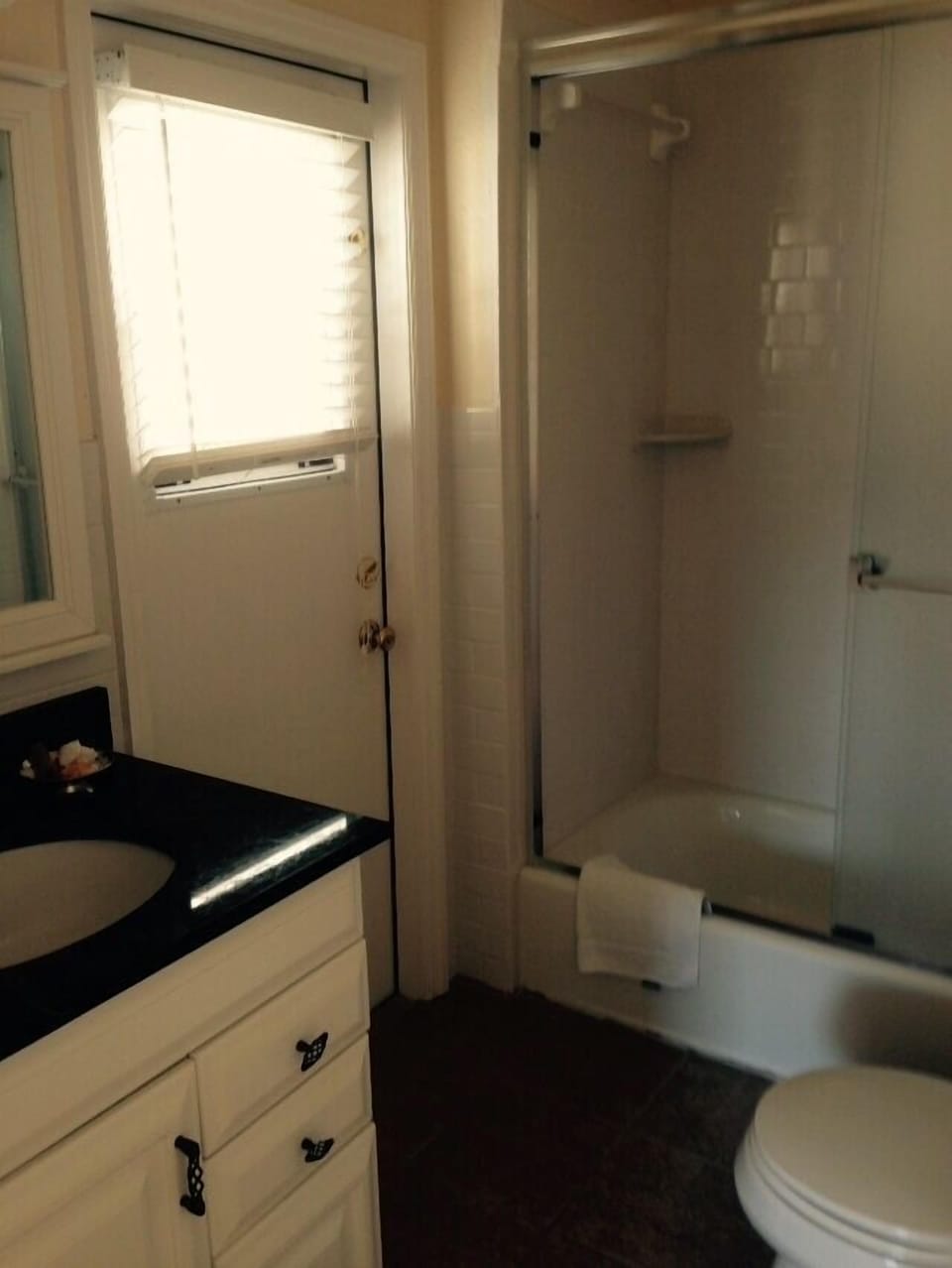 Master bathroom with subway tile, tub, rainforest shower head, marble counter