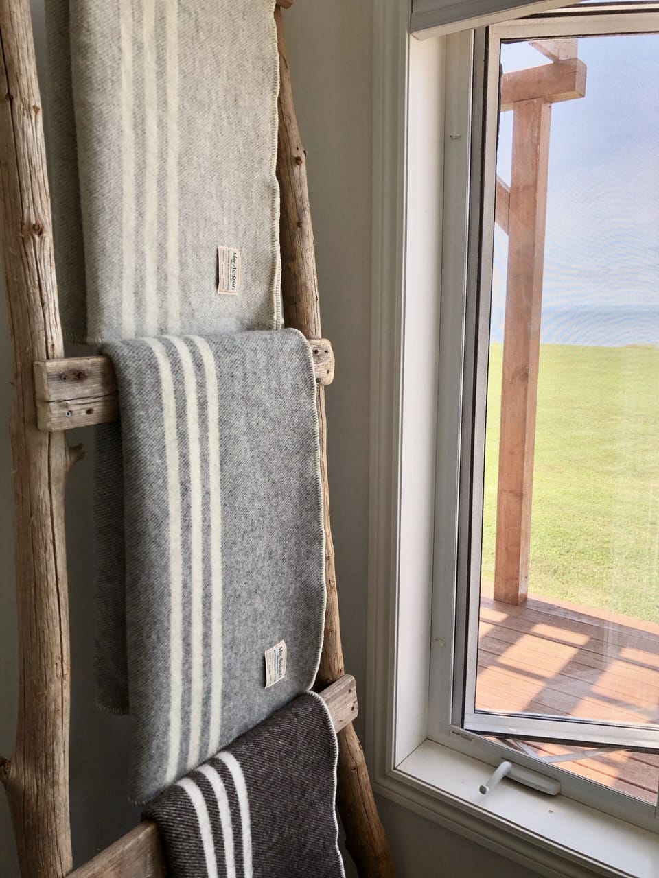 Authentic PEI wool throws on a blanket ladder made from driftwood from our shore