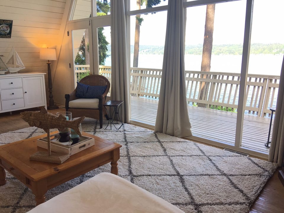 View from the sofa in the living room. Deck continues left toward outdoor dining