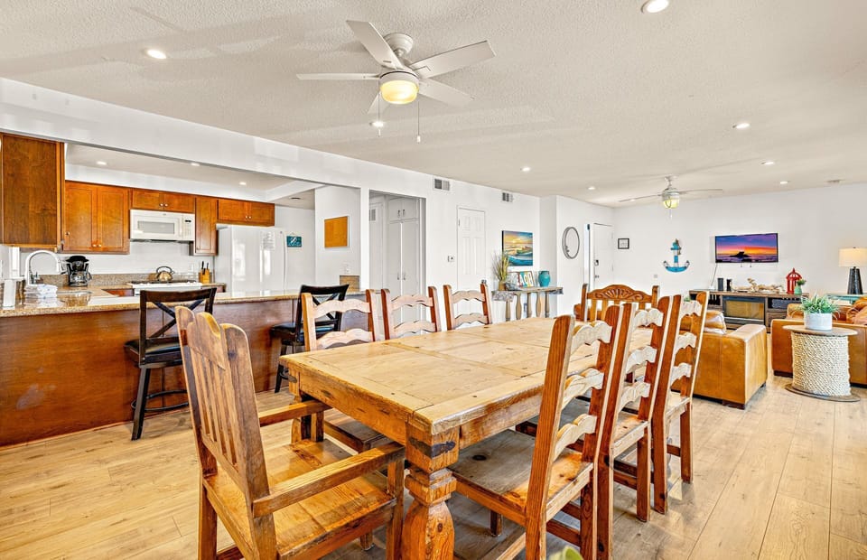 Large family dining table sits adjacent to the kitchen on one side and living room on the other. Perfect for meals, game nights and great conversation!
                