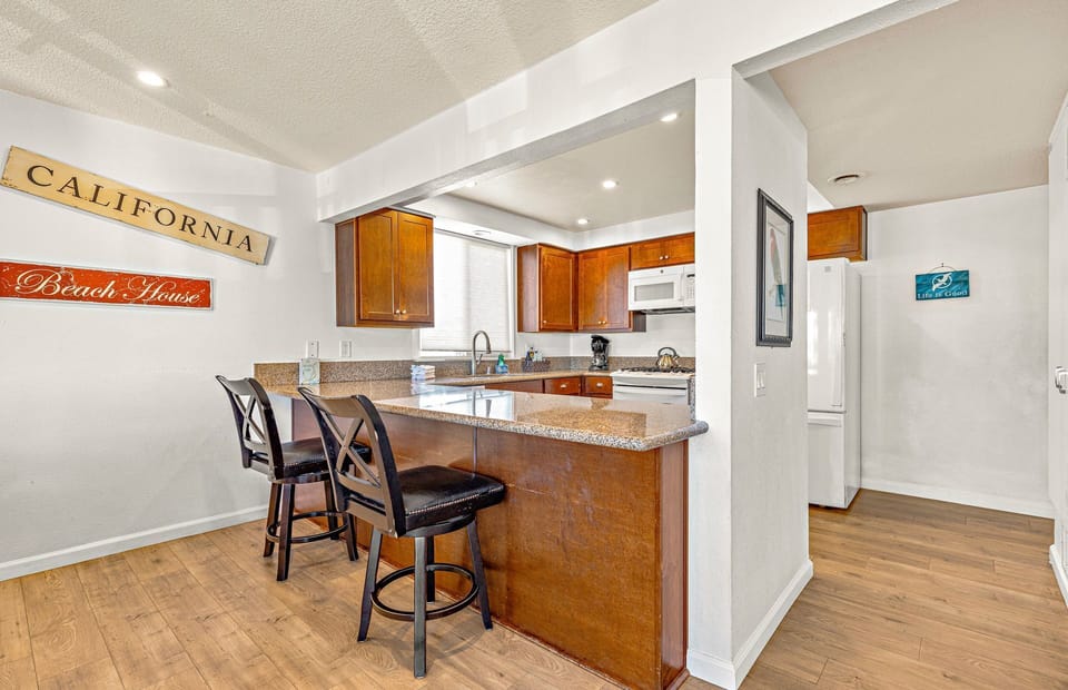 Breakfast bar seating overlooks kitchen headquarters.
                