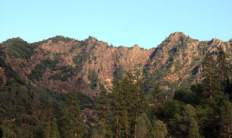 Craggy peaks rise high above the river view from the deck