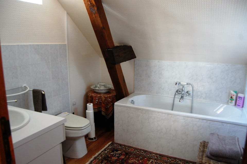 Upstairs bathroom has tub.