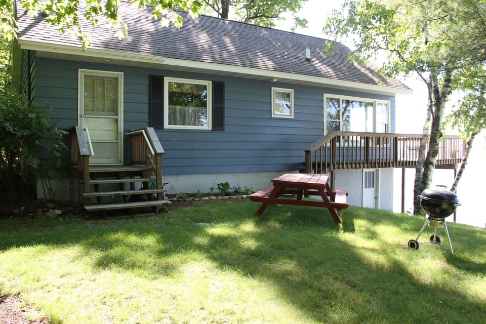 Large yard with picnic table and grill