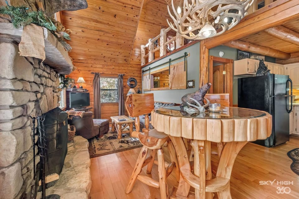 Dining area by the native stone fireplace.