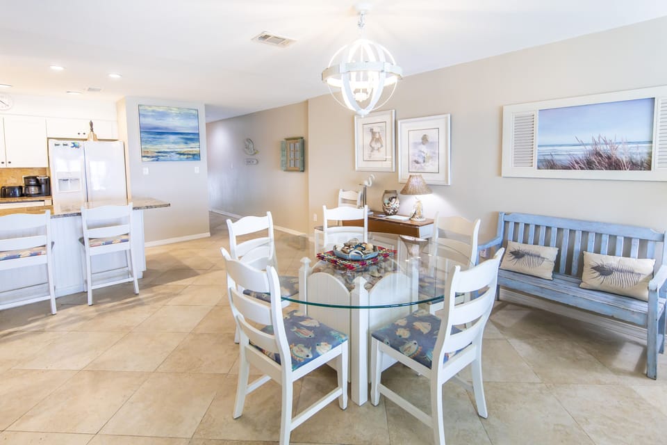 Dining area. Easily seats 6. Add shells to the collection under glass table. 