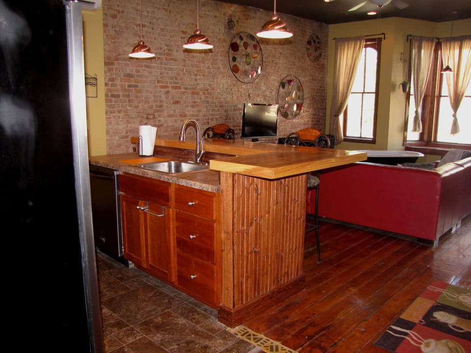 View of kitchen and living-room from the hallway. Loft beds are located above.