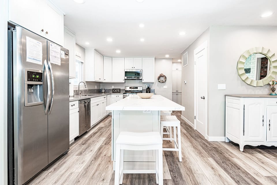Meal prep is a social affair with barstool seating for four and an open floor plan that extends to the living and dining areas.
                