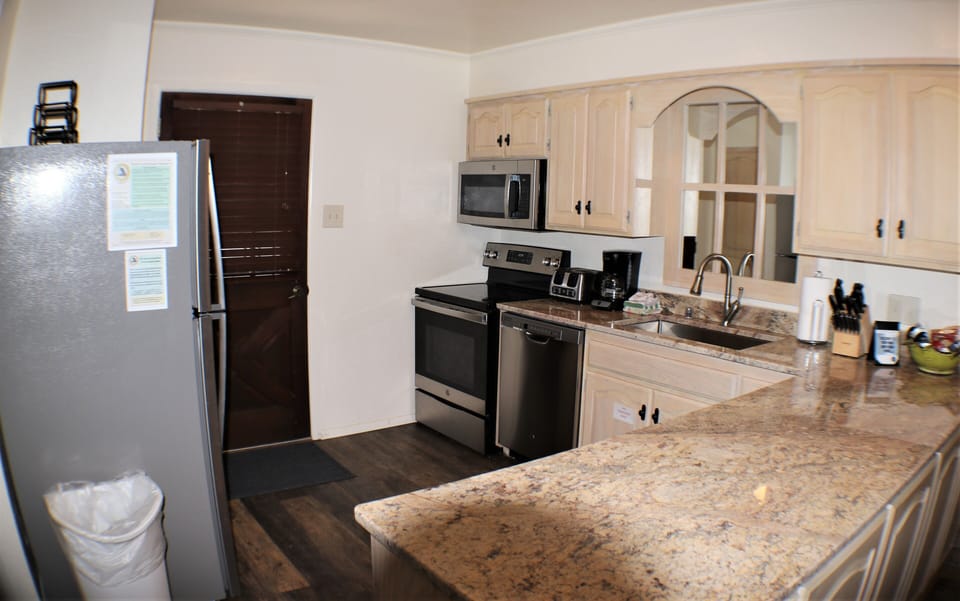 Your fully equipped kitchen features granite countertops, stainless steel appliances, and all the essentials you need to prepare meals just the way you like them.