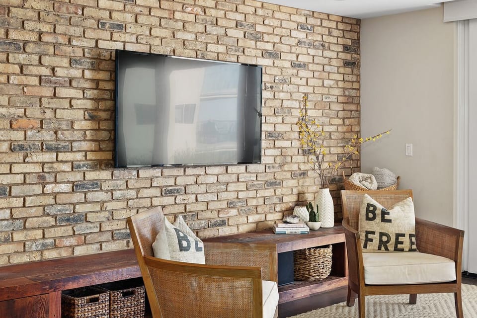 Brick wall adds a nice touch to the stylish decor of the space