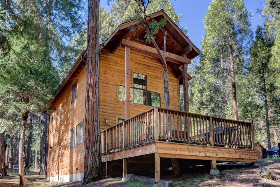 View of front of cabin with deck and gas grill