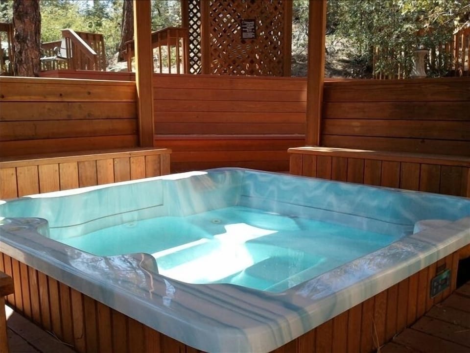 Hot tub on back patio area - and lots of seating area & a sauna too!