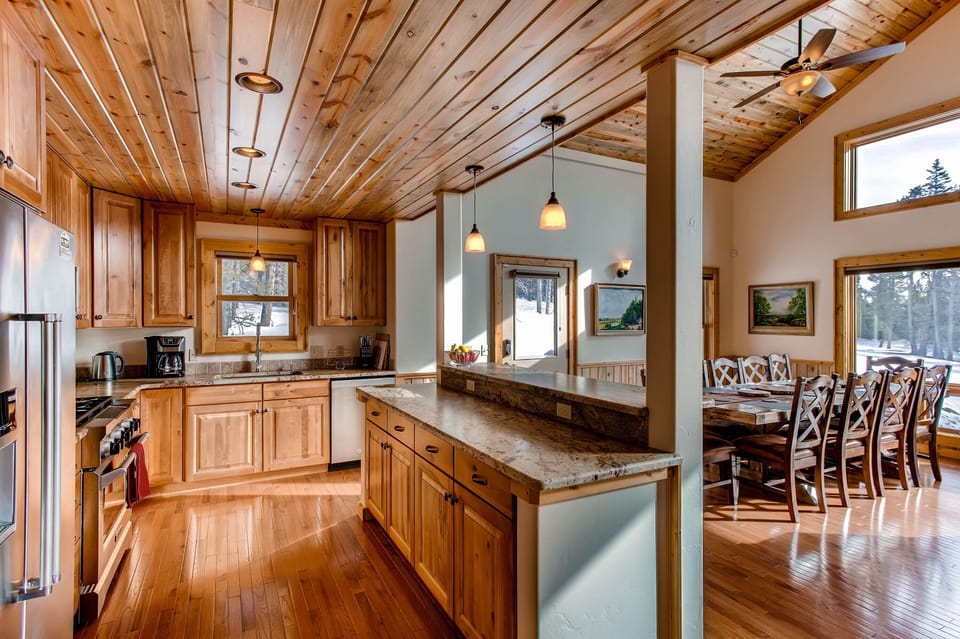 The kitchen is open to the dining room for ease in serving and so that the chef can enjoy talking with the rest of the family or group. All of the gorgeous views are visible from the kitchen, dining room, and great room