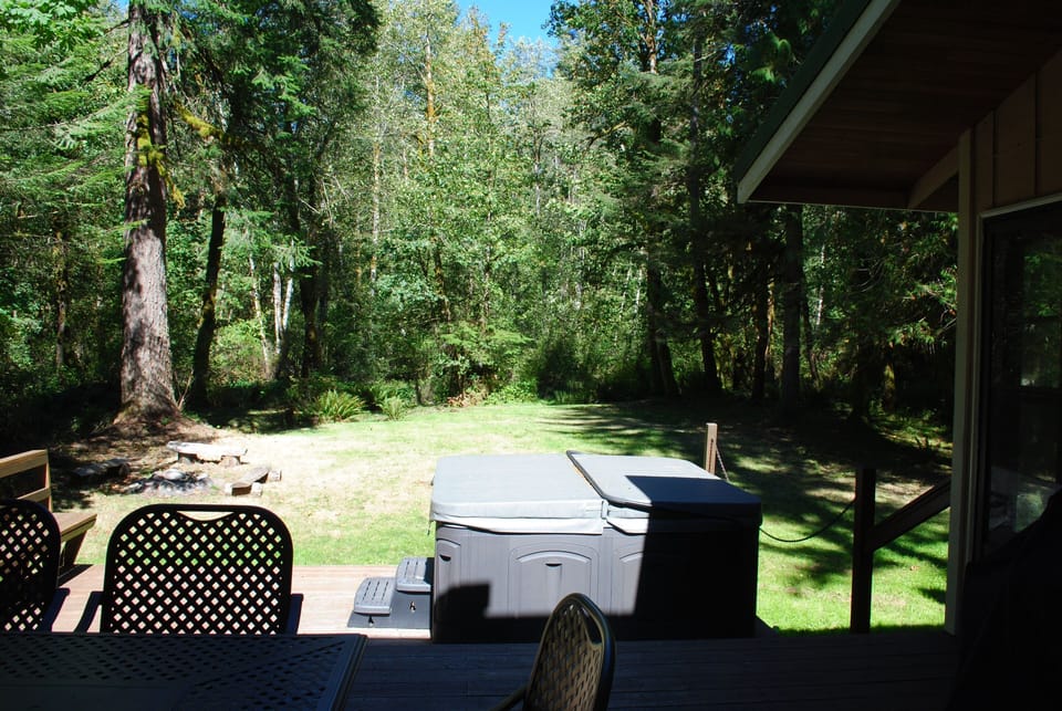Deck off back, hot tub, grassy area, fire pit, outdoor dining table, gas grill