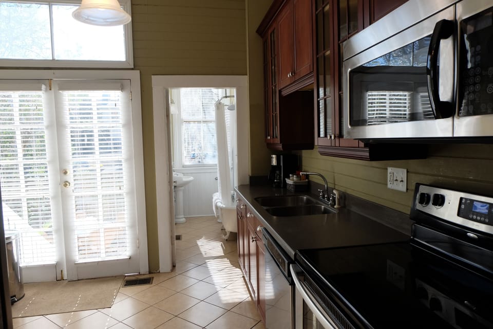 French doors access fenced yard and private parking area