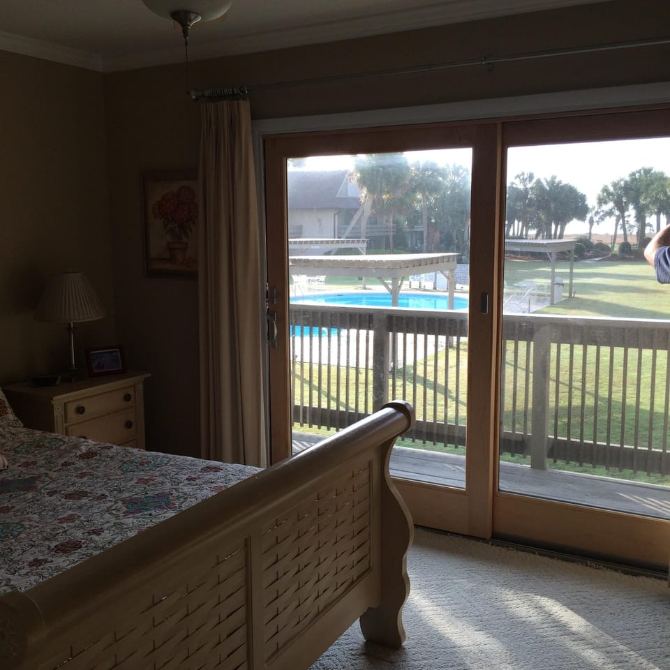 Inside master bedroom looking out over pool courtyard