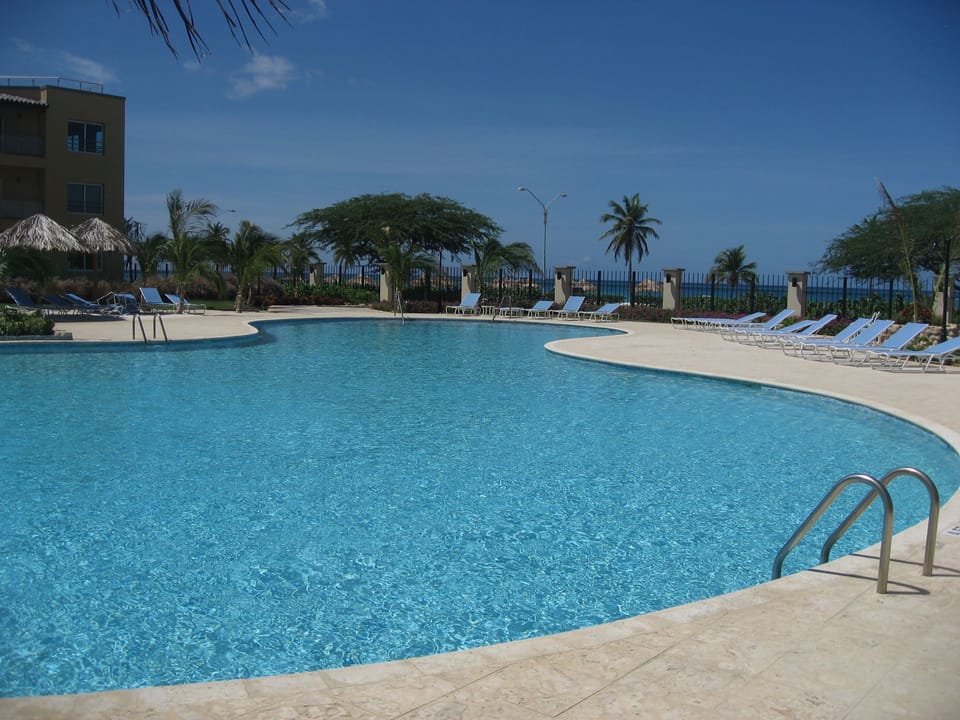 One of the four pools in the resort with loungers