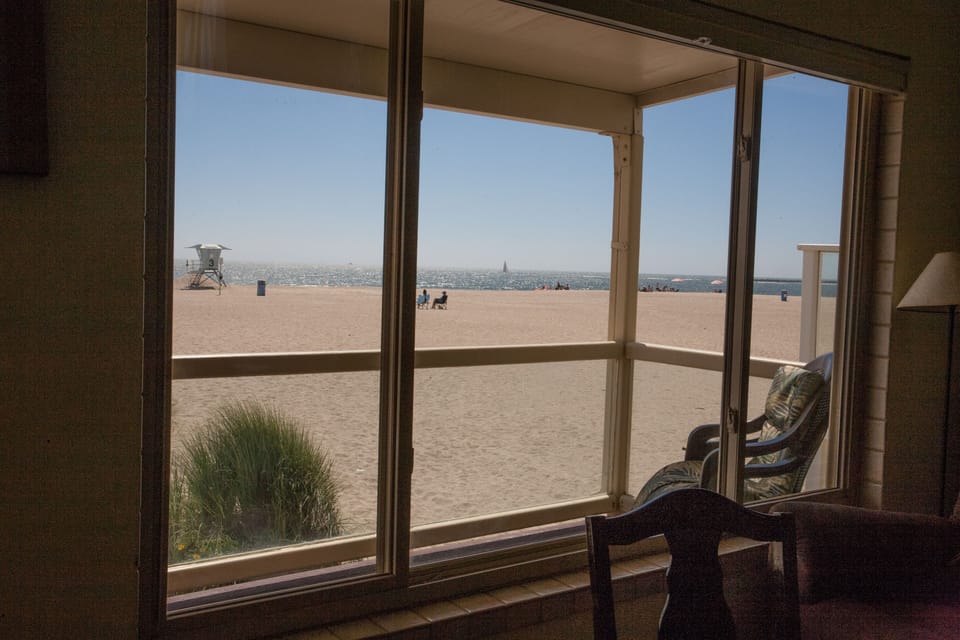 All windows show the ocean and beach