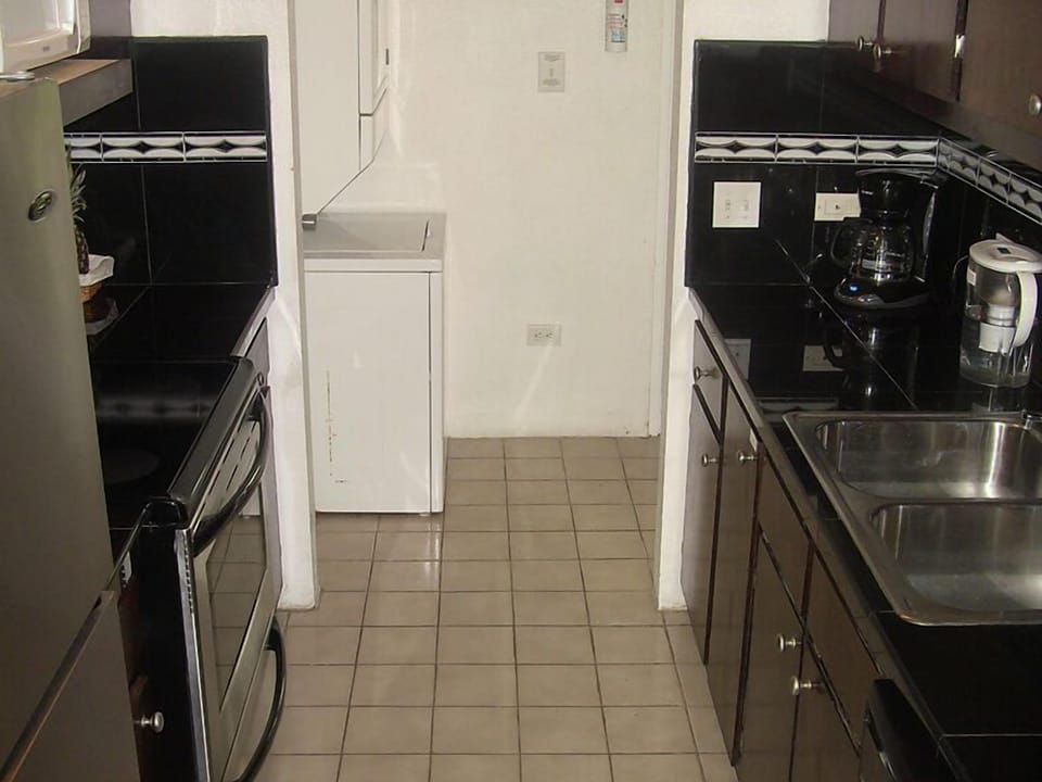 Fully-equipped kitchen with granite countertops and stainless steel appliances.
