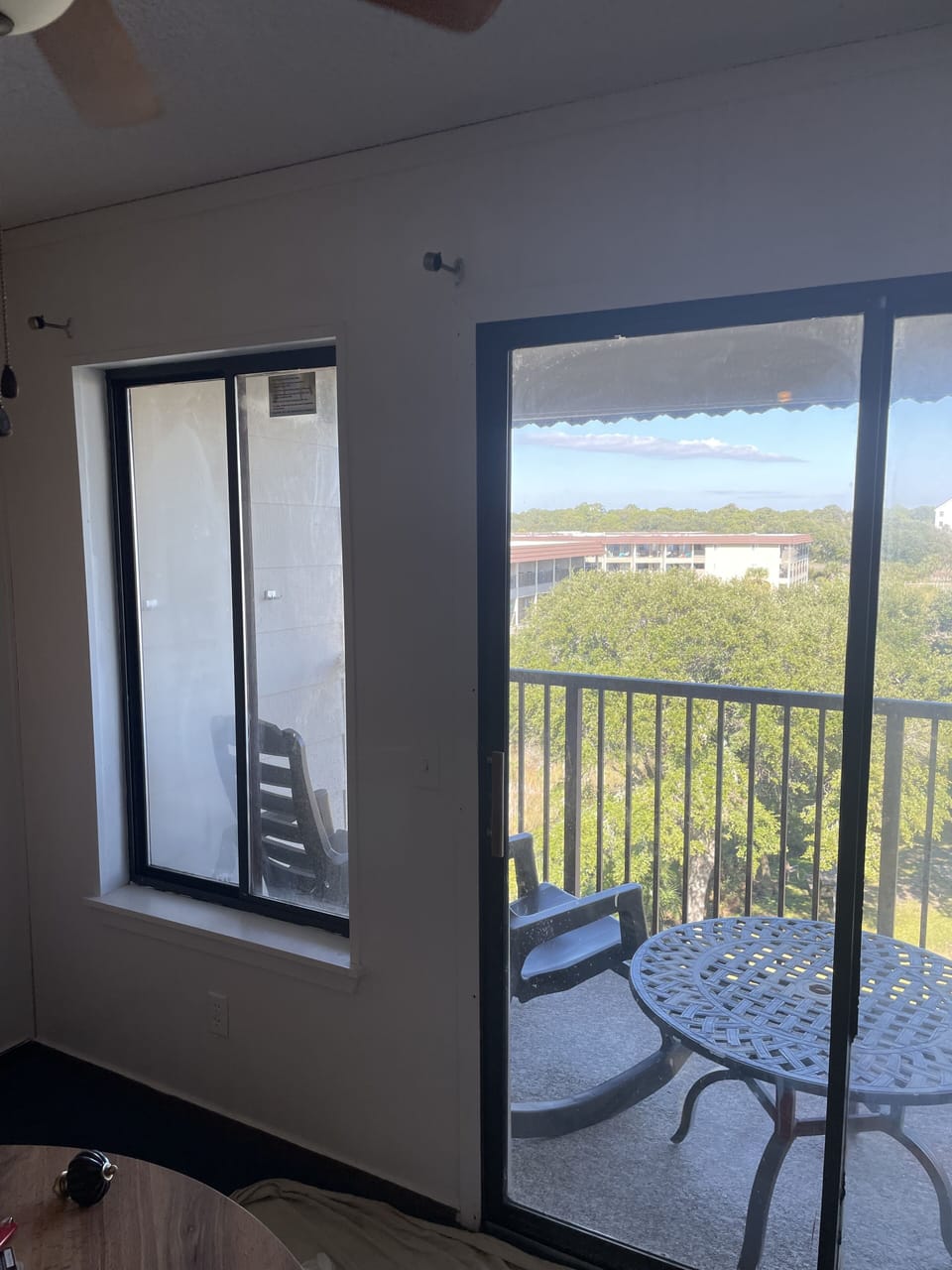 Dining table and sliding door to oceanfront balcony