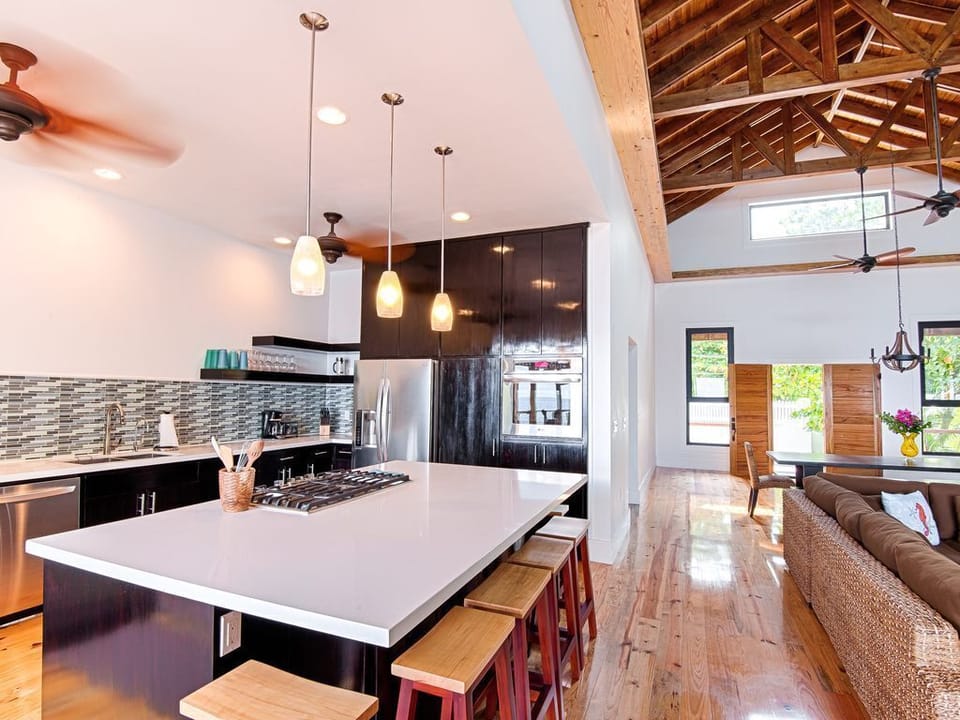 🌿 A gourmet space featuring a large social island, premium stainless steel appliances, and quality cookware. The open design keeps you connected to the Great Room and ocean views while you prep island-fresh meals. 🥂
