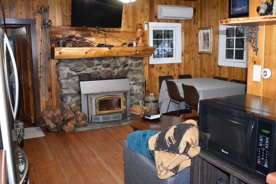 Fireplace with TV/Blu-ray over the mantle. AC/Heat unit above the window.