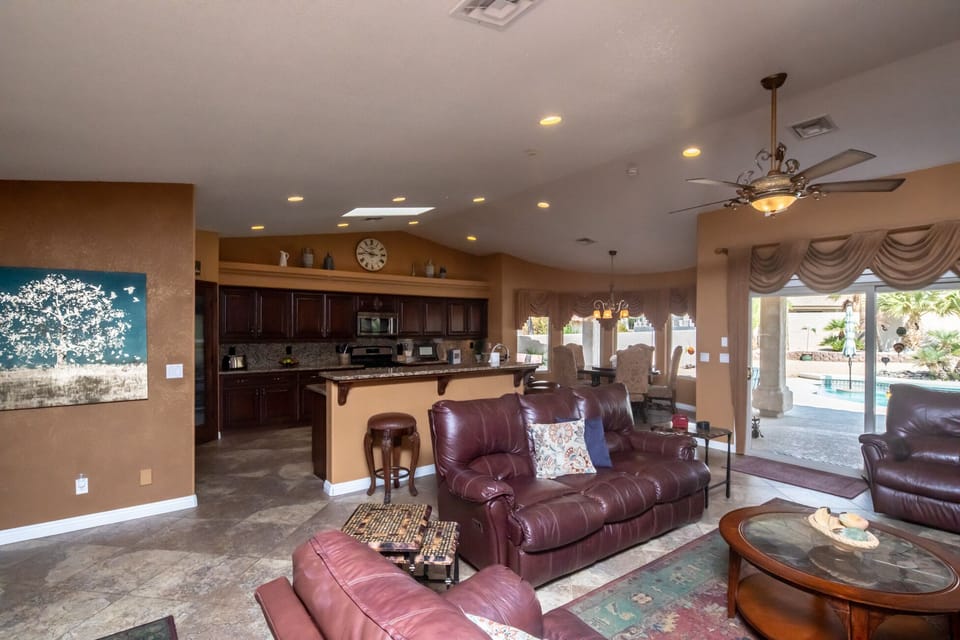 Living room, dining and kitchen has direct view of backyard/pool