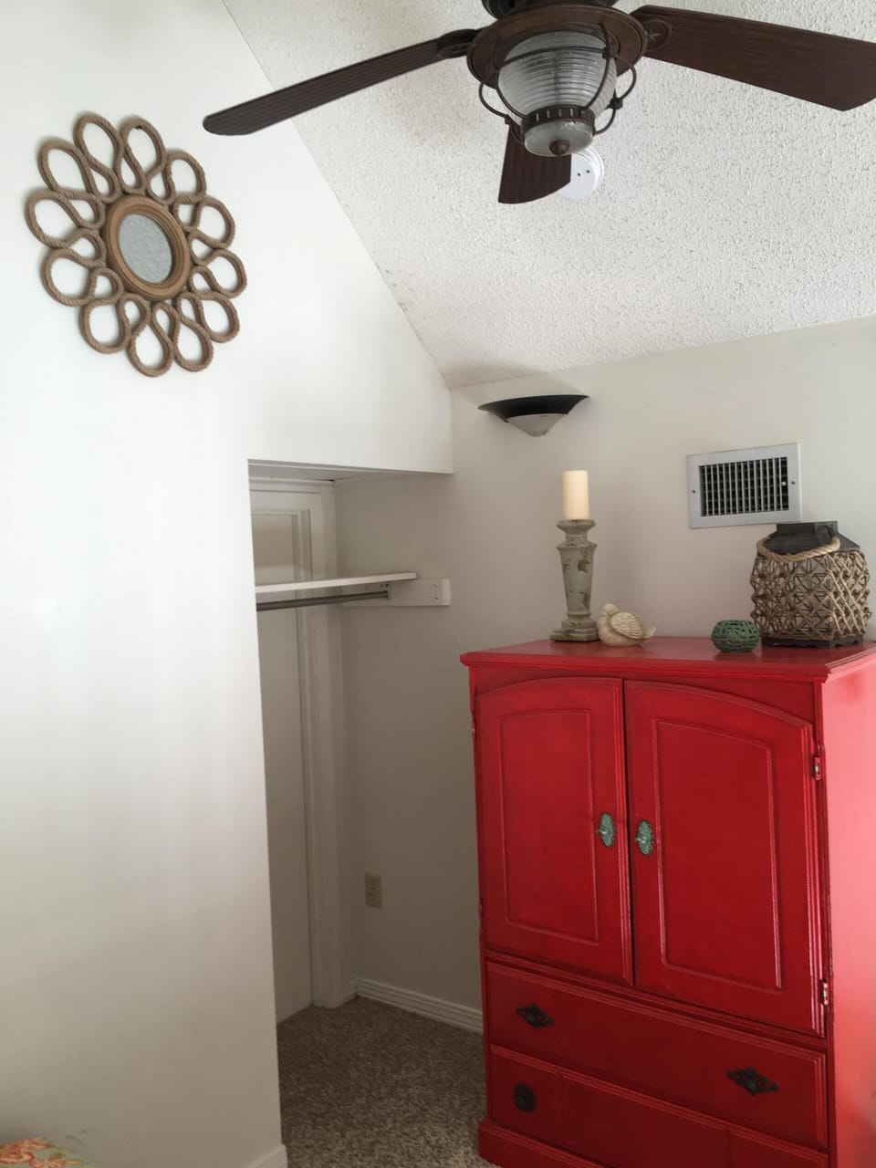 32 inch TV inside red cabinet in loft. 