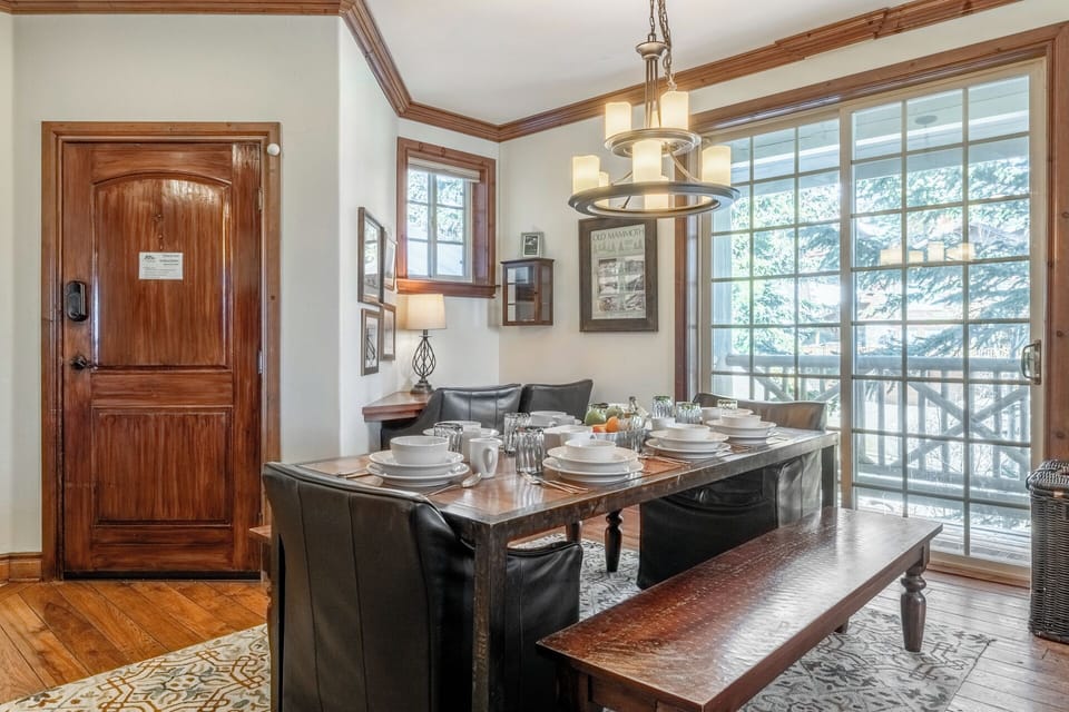 Light-filled dining area with floor-to-ceiling windows and a dedicated workspace, tucked in the corner.