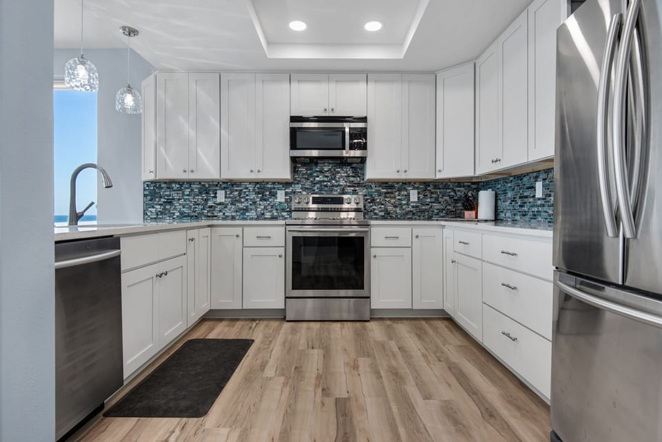 Tray ceiling lights up this beautifully designed kitchen.