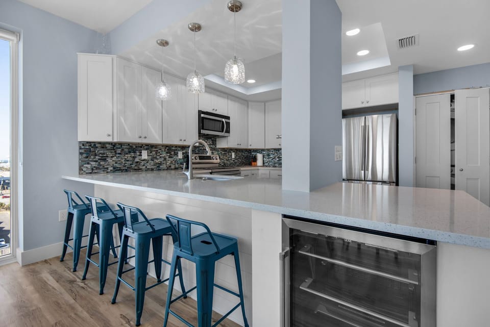 Sit at the bar and enjoy a cocktail from the beverage cooler.