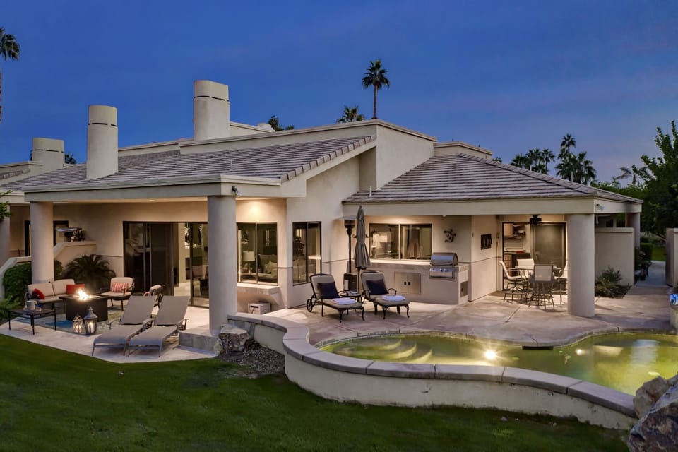 Outdoor living with built-in BBQ, fire table, outdoor furniture & lounge chairs