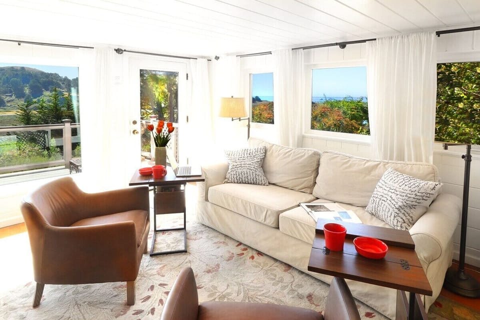 The sofa is deep and comfortable for watching TV or using as a sofa bed. The room also has a kitchenette with a mini frig, a washer and dryer and convenient access to the deck. The view over the river reaches out to the ocean.