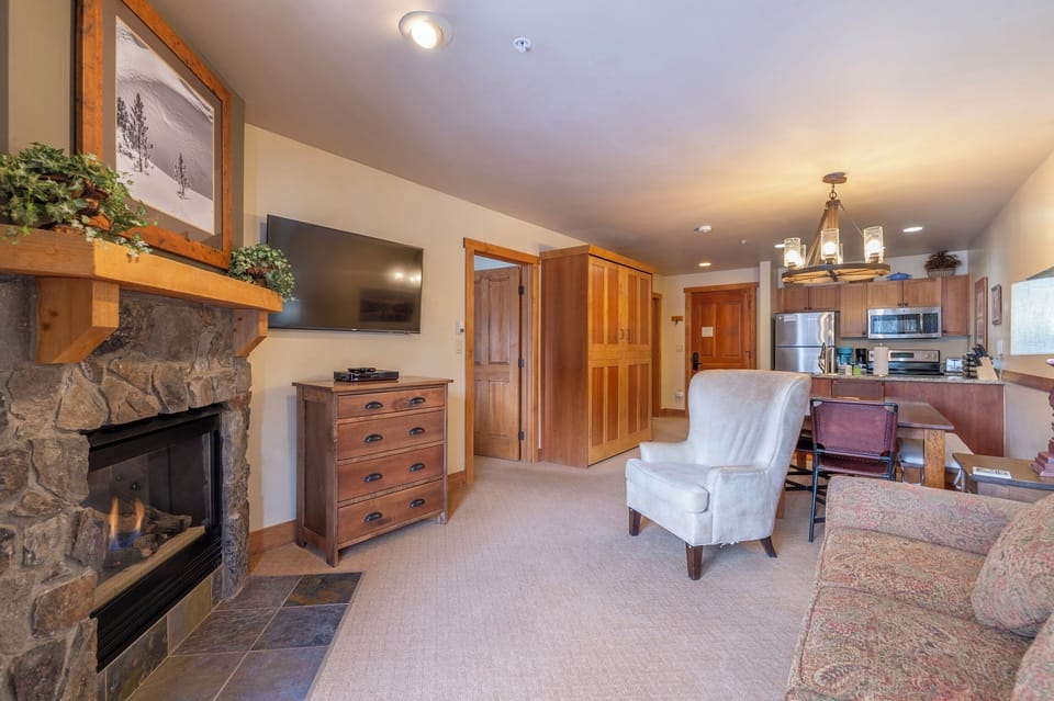 Living Room has stone fireplace, TV1, private deck, Queen fold-out & Murphy bed.
