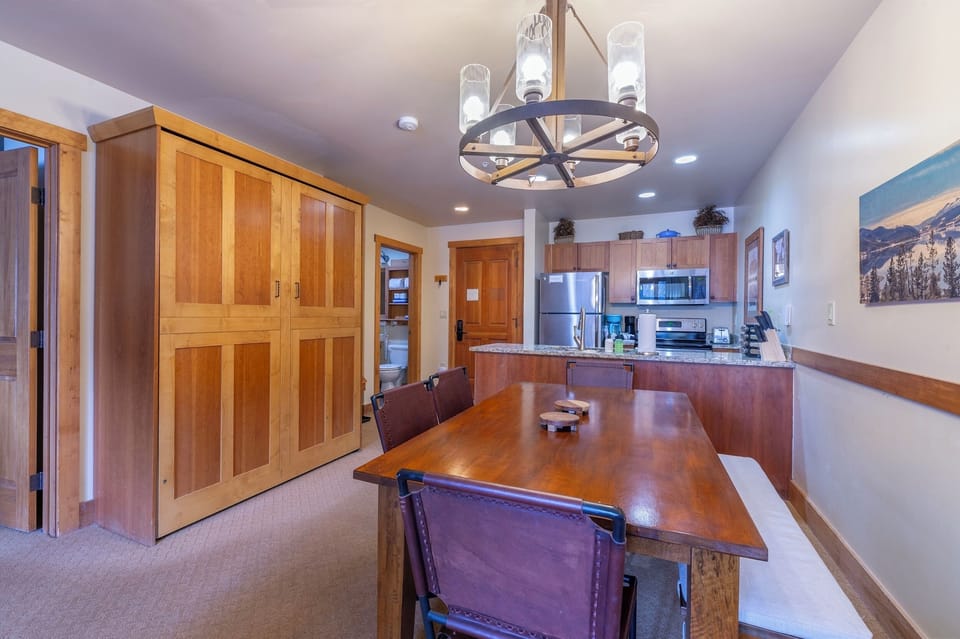 Murphy bed cabinet (left wall), dining area, and kitchen. 